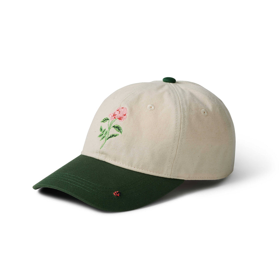 Beige cap with embroidered rose design on a white background