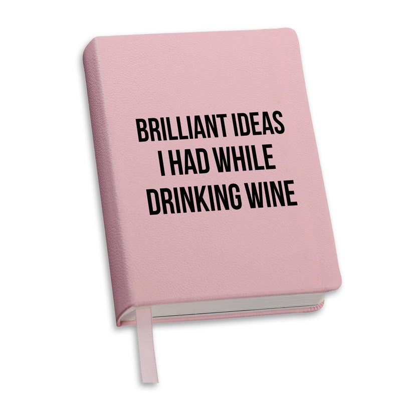 Pink hardcover journal with 'Brilliant Ideas I Had While Drinking Wine' text printed on cover