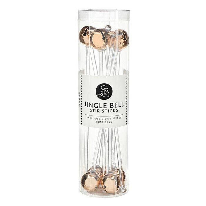 rose gold, A clear cylindrical package containing rose gold jingle bells stir sticks, with a white label reading 'JINGLE BELL STIR STICKS' and 'INCLUDES 8 STIR STICKS ROSE GOLD'.