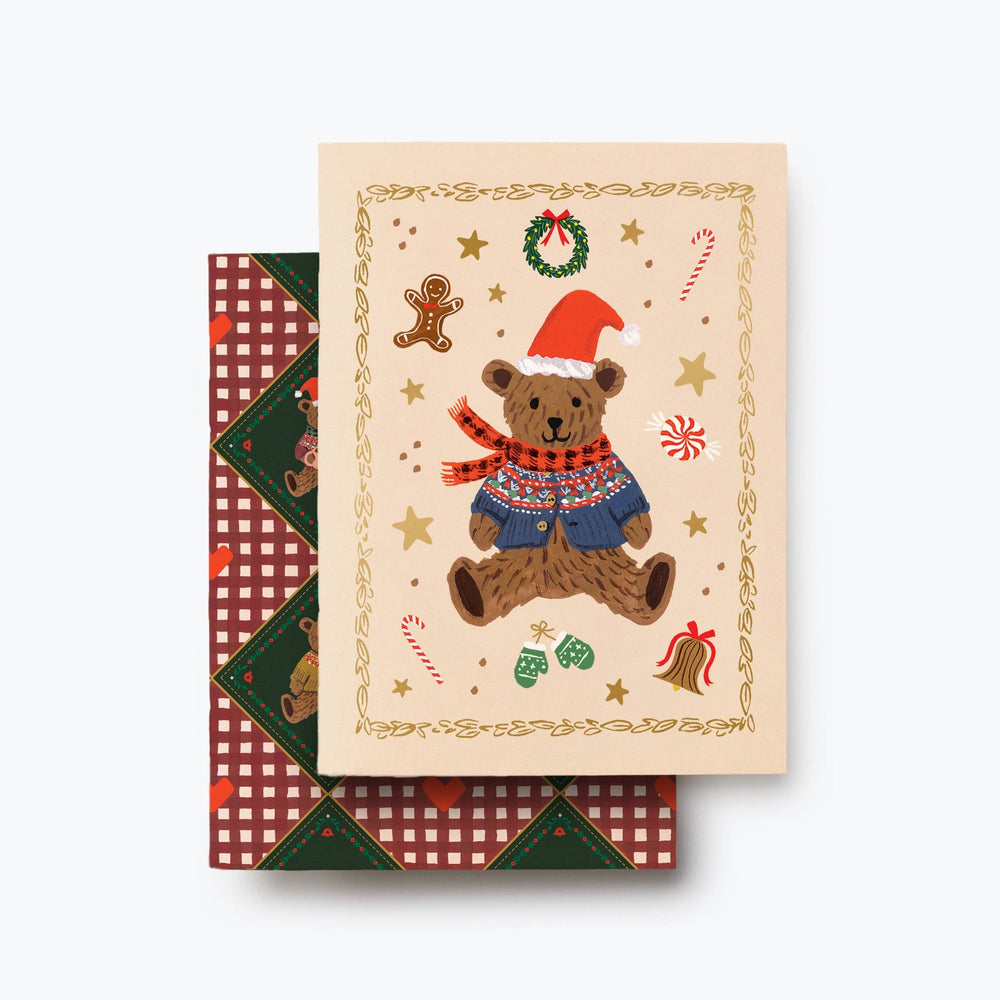 Two festive pocket notebooks with teddy bear and Christmas-themed designs in cream and burgundy patterns.