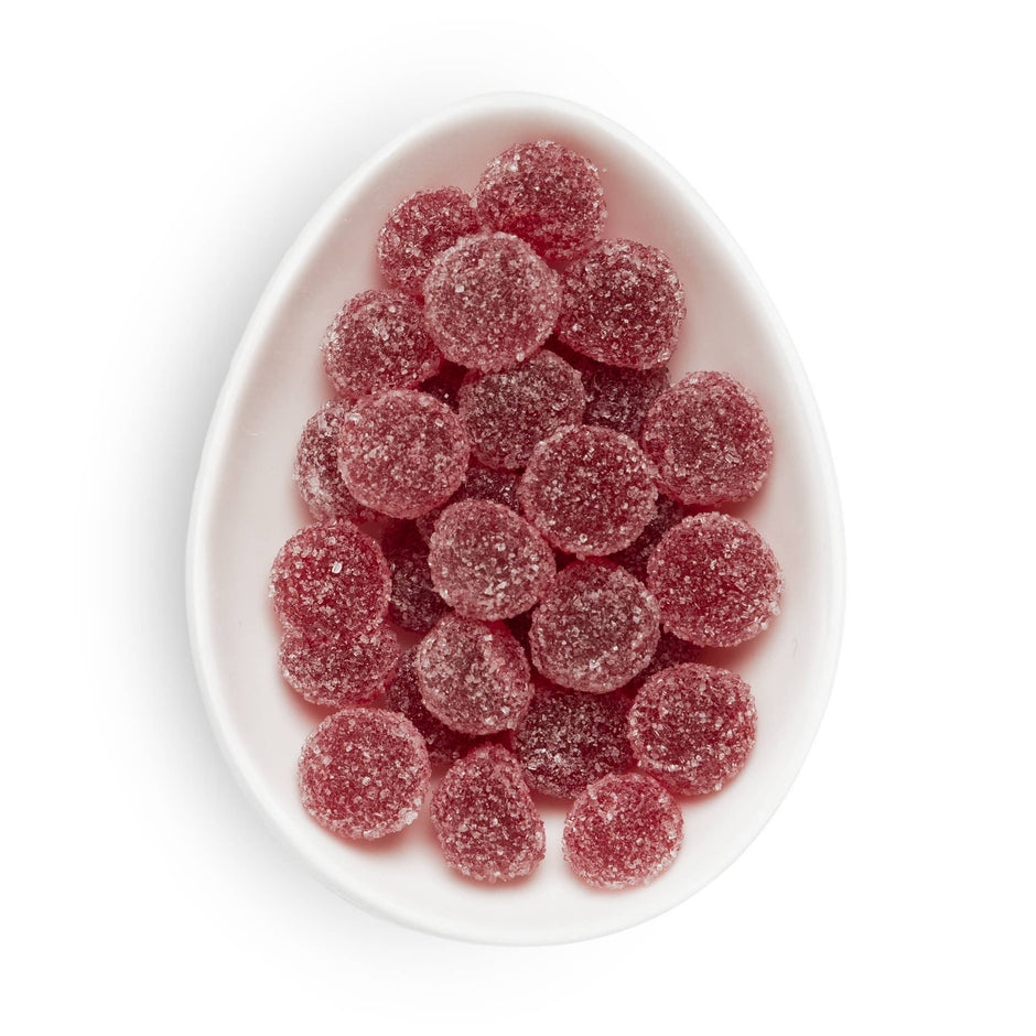 Sugarfina Sugared Cranberries in a white oval dish on neutral background