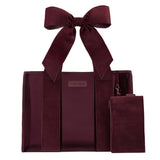 Burgundy velvet tote bag with matching bow detail and small pouch, displayed against white background.