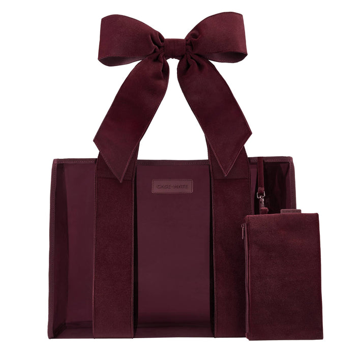 Burgundy velvet tote bag with matching bow detail and small pouch, displayed against white background.
