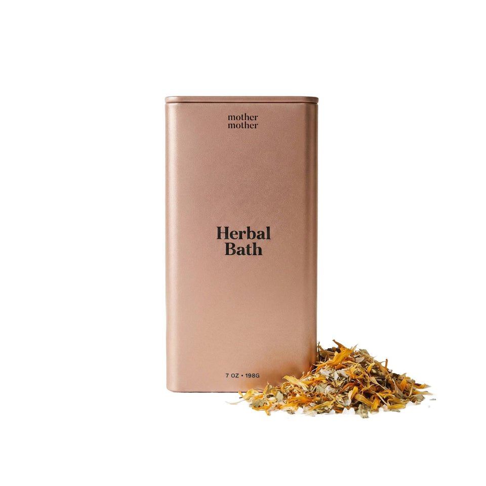Mother Mother Organic Herbal Sitz Bath 7oz in rose gold tin with dried herbs displayed