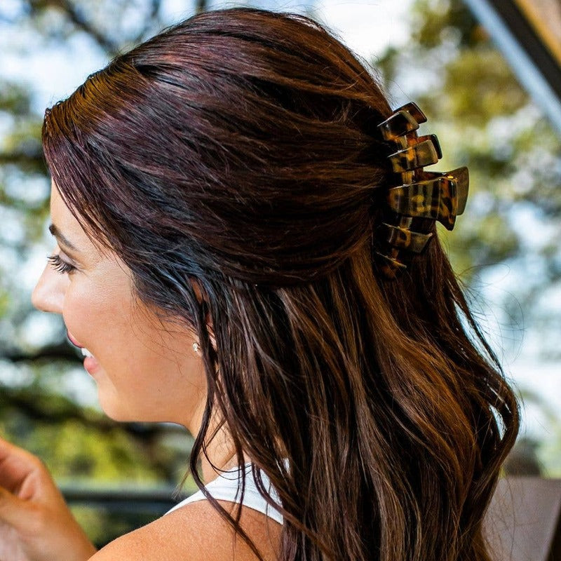 Tortoise medium hair clip worn in long brunette hair with highlights, outdoor setting