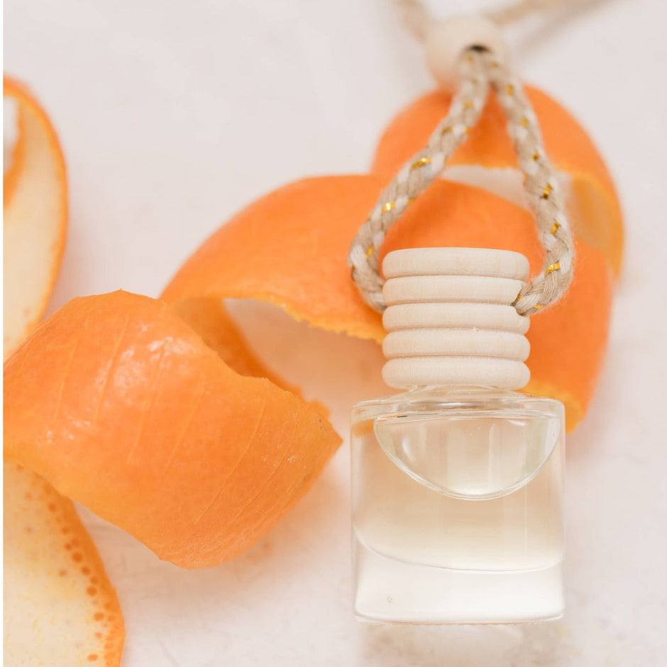 Satsuma car diffuser with mandarin peel and cream ceramic stopper on white background