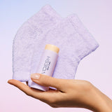 Hand holding VOESH New York Lavender Heel Repair Duo with fluffy purple towels in background