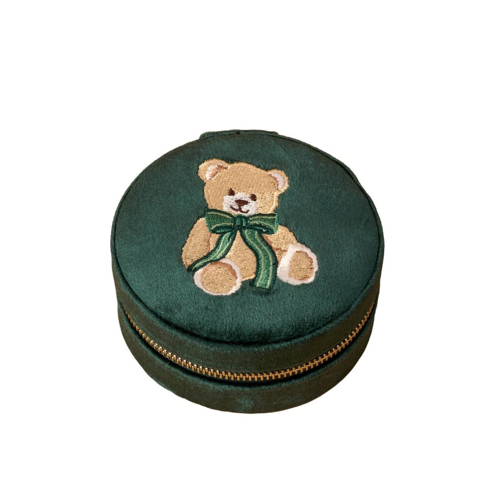 Green velvet round jewelry case with embroidered teddy bear and green bow, gold zipper detail