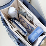 Case-Mate Tote Organizer in French Vanilla filled with travel essentials and personal items