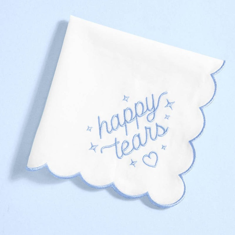 White handkerchief with scalloped edges and blue 'happy tears' embroidery with stars and heart