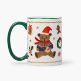 Green-handled porcelain mug with festive teddy bear design and holiday decorations