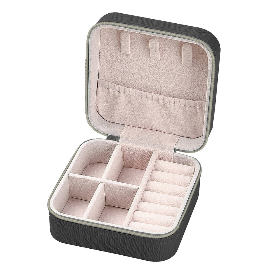 Black travel jewelry box with pink velvet interior compartments, open to show storage organization