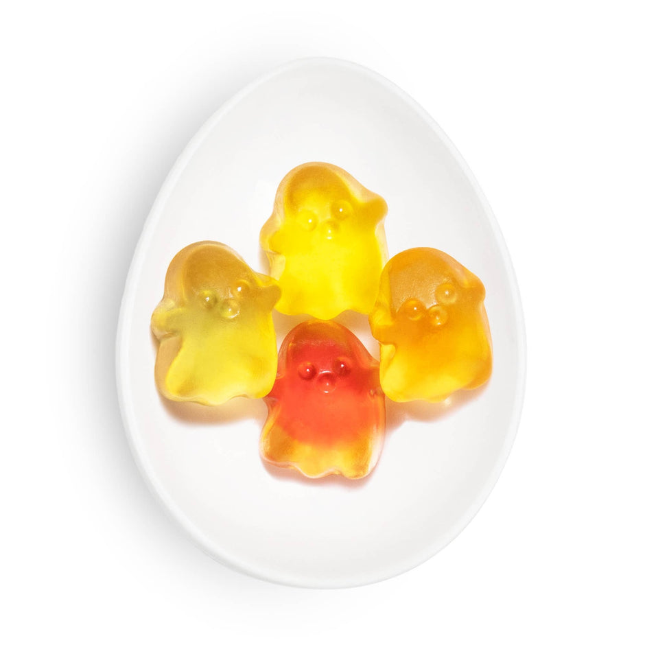 Sugarfina spooky ghost gummy candy in yellow and red on white plate