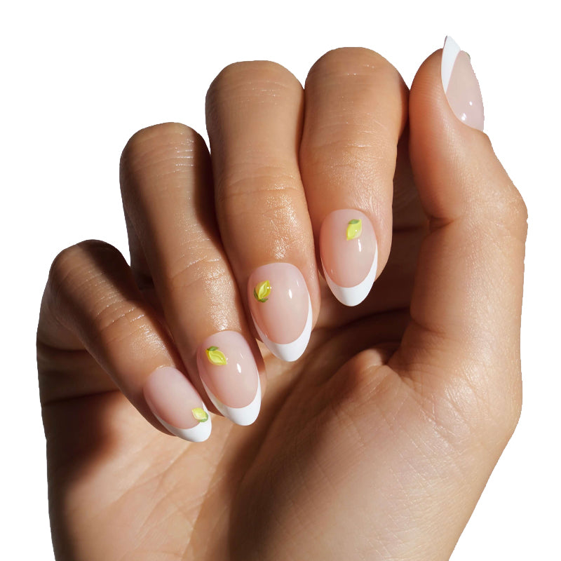 Hand with French manicure nails featuring a white tip and green leaf design on a white background