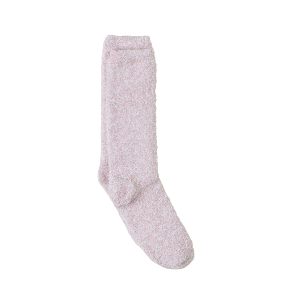 A pair of knee-high fuzzy socks in a light dusty pink color, shown against a plain white background.
