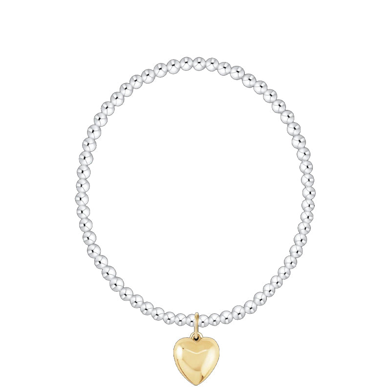 Bracelet with a gold heart charm on a white background
