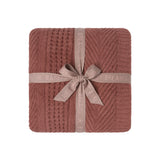 CozyChic Holiday Waffle Cable Throw in Faded Brick, folded and tied with a ribbon bow