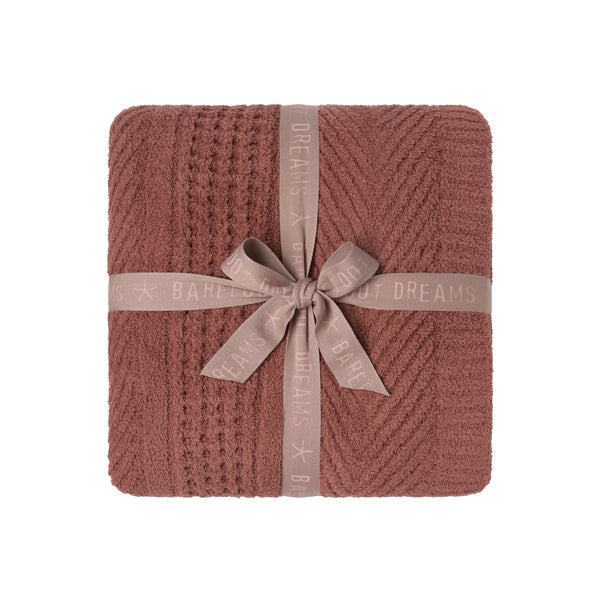 CozyChic Holiday Waffle Cable Throw in Faded Brick, folded and tied with a ribbon bow
