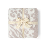 CozyChic Lush Knit Leopard Throw in Cream, folded and tied with a ribbon bow