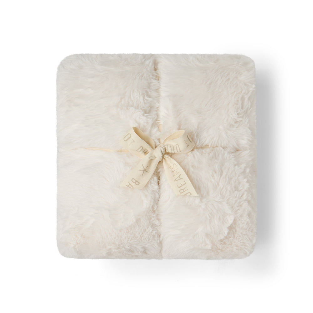Cream, Cloud Faux Fur Throw in Cream, folded and tied with a ribbon bow
