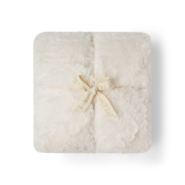 Cream, Cloud Faux Fur Throw in Cream, folded and tied with a ribbon bow