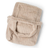 Dream Channel faux fur blanket tucked into its matching Sandstone bag