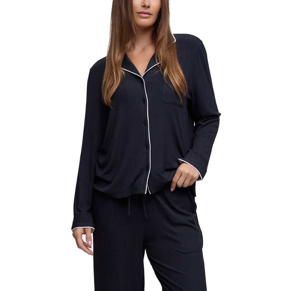 Model wearing the Ultra Soft Rib sleep shirt and pant in Black with white piping, front view