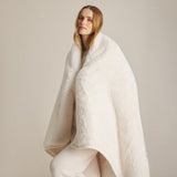 BAREFOOT DREAMS | Cloud Faux Fur Throw — Cream, woman wearing blanket over her shoulders