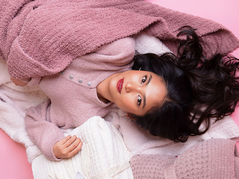 Cozy pink loungewear and blanket styled for dorm room comfort