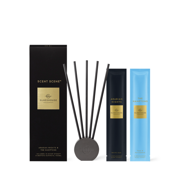 Glashouse Scent Scene Arabian Nights & The Hamptons diffuser set, featuring a black outer box, a black reed diffuser base with five dark reeds, a dark blue Arabian Nights pouch, and a light blue The Hamptons pouch, all with gold labels on a white background.
