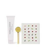 Cosmetic tube, gold spoon, and card with illustrations on a white background