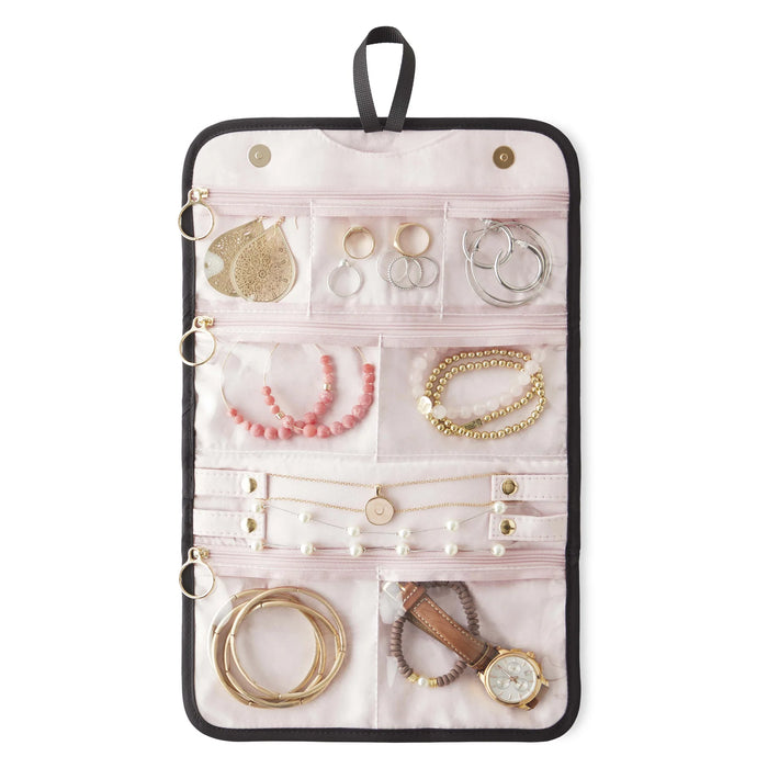 KUSSHI Travel Jewelry Organizer open and filled with earrings, bracelets, necklaces and rings in zip pockets with blush lining
