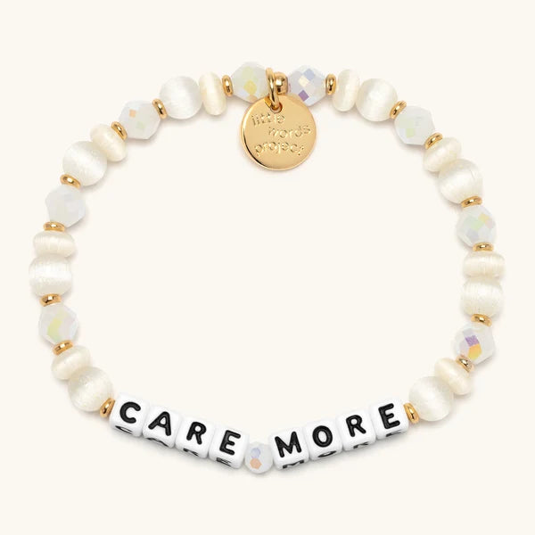 Care More bracelet in cream and buttercup beads with black letter beads, Dolly Parton's Imagination Library
