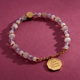 Keep Moving Forward charm bracelet on a burgundy backdrop