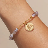 Keep Moving Forward charm bracelet worn on a wrist