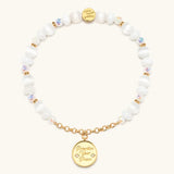 Prioritize Your Peace charm bracelet with white beads and a gold medallion