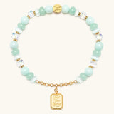 Trust Your Journey charm bracelet with seafoam beads and a gold medallion