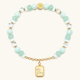 Reverse of the Trust Your Journey bracelet charm showing the sun and winding road