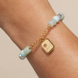 Trust Your Journey charm bracelet worn on a wrist, charm turned to the back