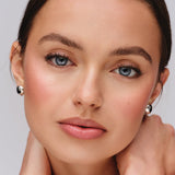 Model wearing Westman Atelier Petite Party blush and highlighter with defined eyes