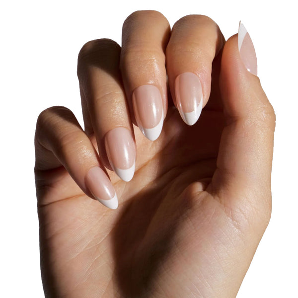 Close-up of a hand with beige nail polish on a white background