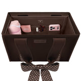 Brown Case-Mate Tote Organizer with polka dot handles, filled with pink accessories and phone case