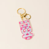Pink floral acrylic sorority letter keychain with gold hardware on neutral background