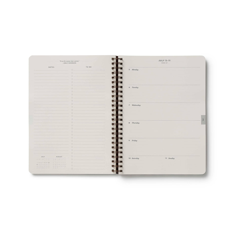 Spiral-bound notebook with a minimalist design on a white background
