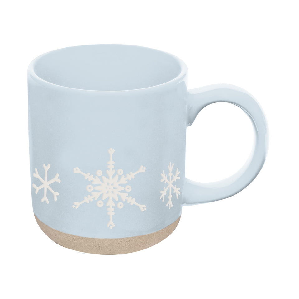 Light blue stoneware coffee mug with white snowflake design and cork bottom