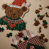 Beary Christmas Mini Jigsaw Puzzle partially assembled on a neutral surface with scattered pieces