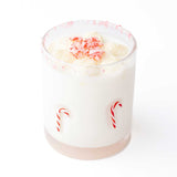 Candy cane icon drinking glass filled with white creamy beverage topped with red and white sprinkles