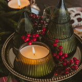Fraser Fir Soy Candle in decorative glass tree jar displayed in festive holiday centerpiece with berries and greenery