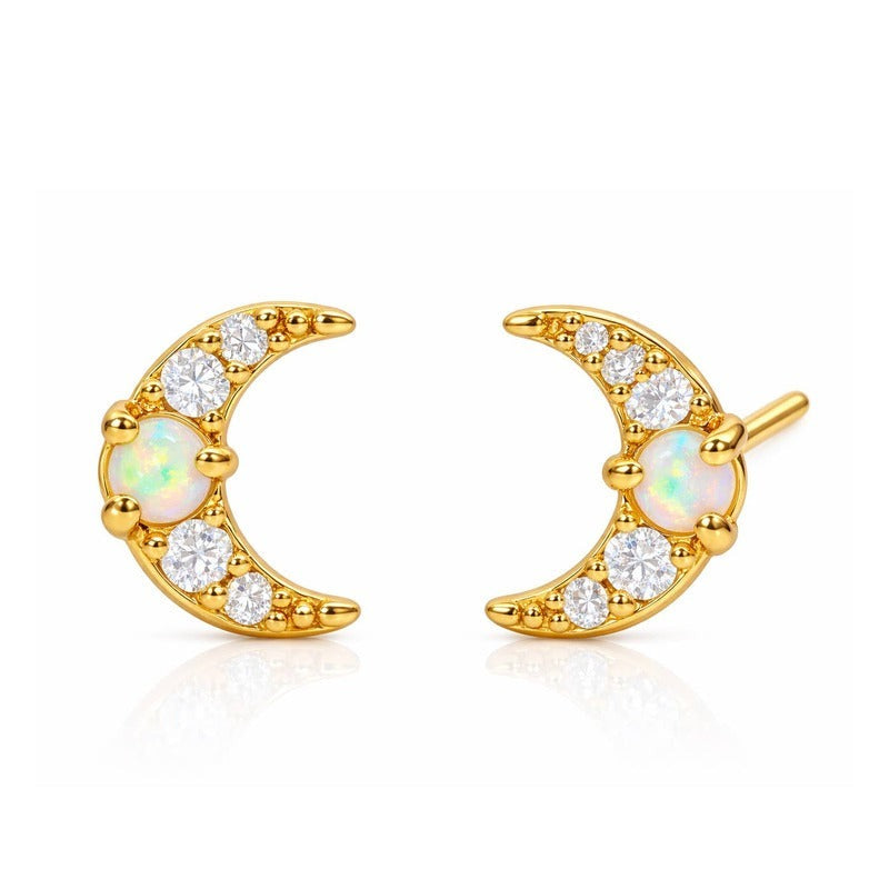 Gold moon stud earrings with opal center and diamond accents on white background