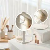 FANCII Tara 10x magnifying mirror in minimalist bedroom vanity setup with makeup brushes and cosmetics